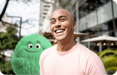 A man laughing beside the CashPal mascot