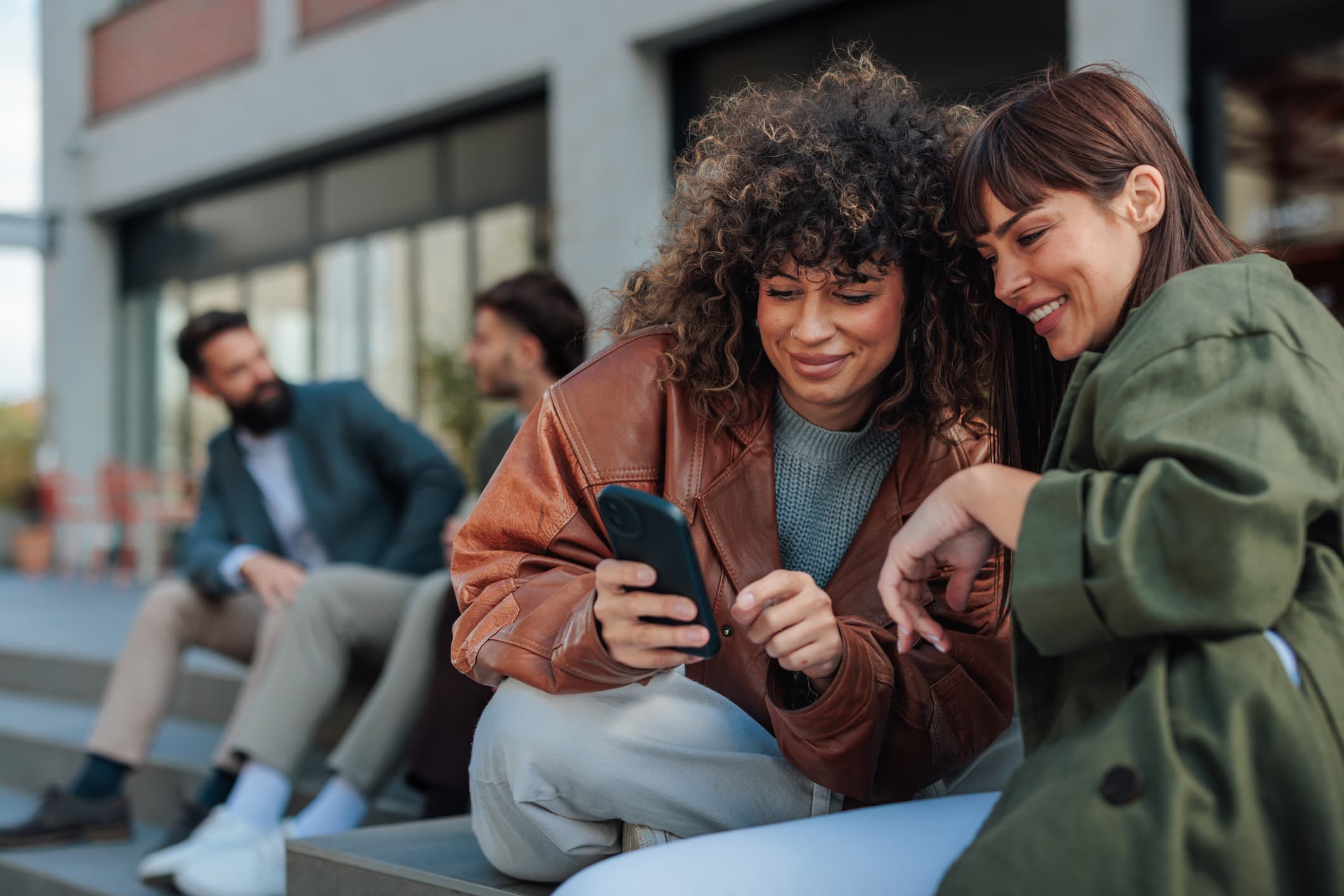 Two friends looking at a phone
